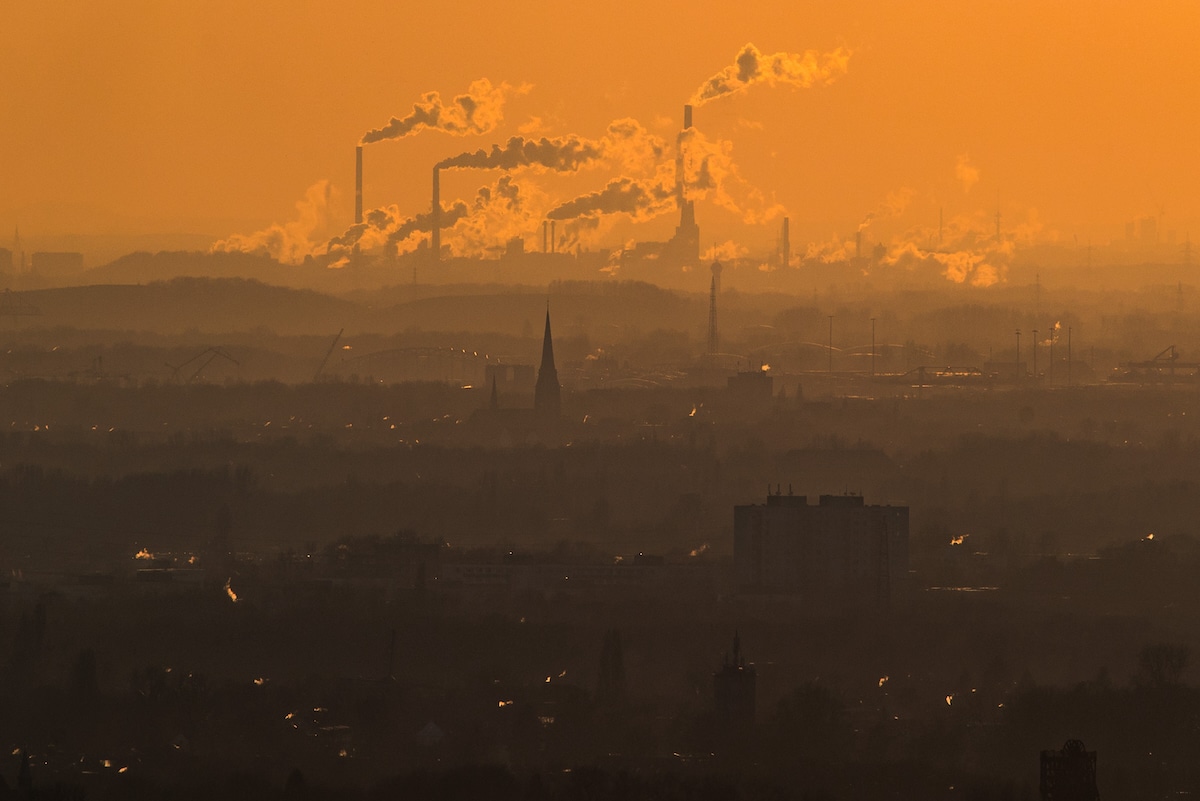Steam and exhaust rise from heavy industry over the town of Oberhausen, Germany